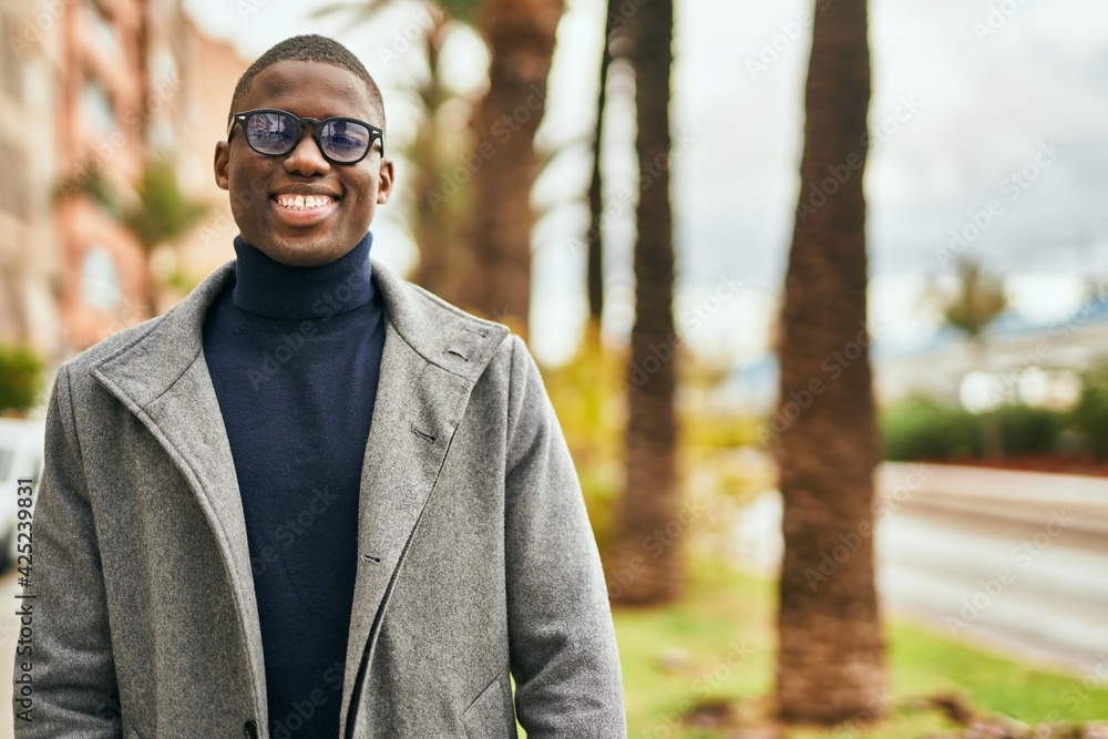 Young african american man smiling happy standing at the city Young african american man smiling happy standing at the city