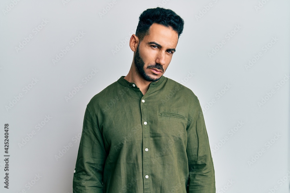 Young hispanic man wearing casual clothes skeptic and nervous, frowning upset because of problem. negative person. Young hispanic man wearing casual clothes skeptic and nervous, frowning upset because of problem. negative person.