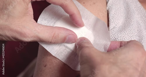 Covering arm's sutured wound at home after medication