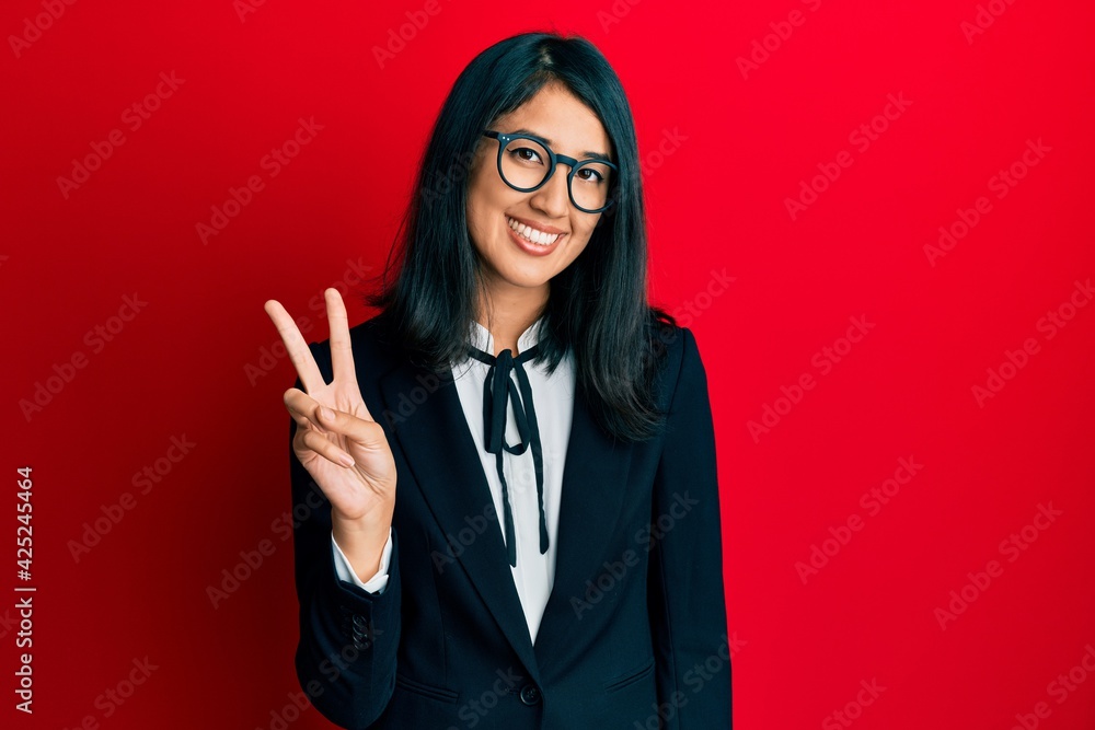 Beautiful asian young woman wearing business suit showing and pointing up with fingers number two while smiling confident and happy. Beautiful asian young woman wearing business suit showing and pointing up with fingers number two while smiling confident and happy.