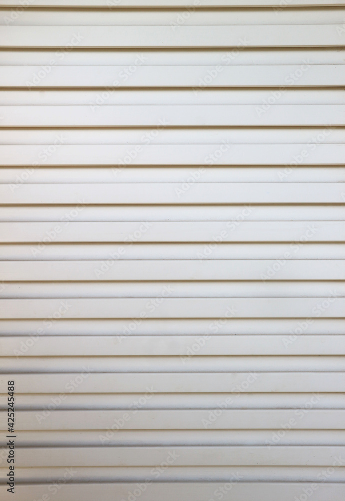 Closeup of the grille pattern on the white PVC door . Closeup of the grille pattern on the white PVC door .