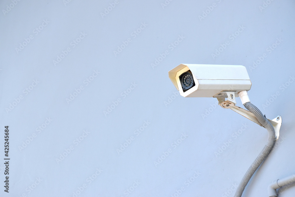Security camera, CCTV on the blue wall in city Security camera, CCTV on the blue wall in city