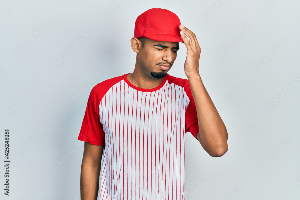 Young african american man wearing baseball uniform smiling in love showing heart symbol and shape with hands. romantic concept.