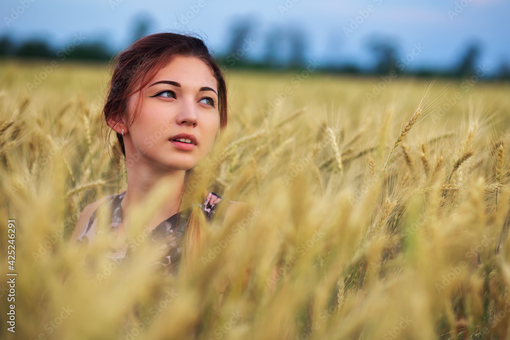 Beauty Girl Outdoors enjoying nature. Beautiful Teenage Model girl in dress on the Spring Field Beauty Girl Outdoors enjoying nature. Beautiful Teenage Model girl in dress on the Spring Field