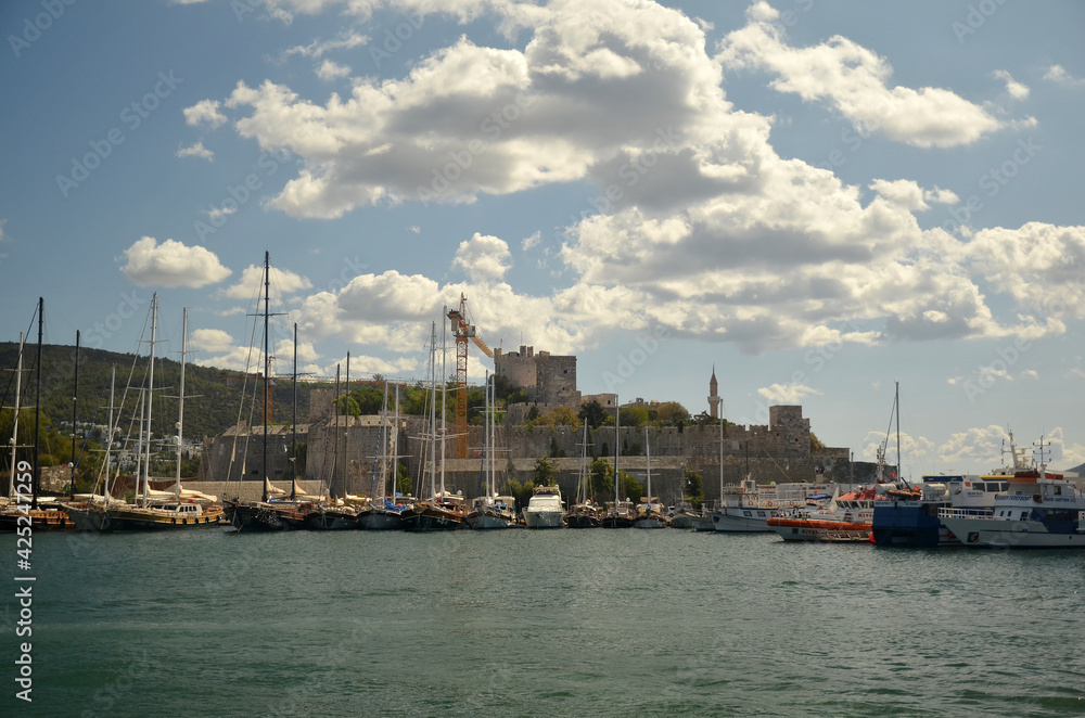  View to Bodrum  coastline from the sea. Beautiful yachts  and boats stay in the row. Castle on the background. Marine landscape. Travel concept