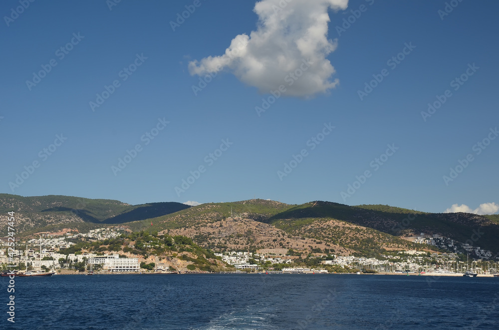 Beautiful landscape of mountains on the horizon in the Aegean Sea. Blue ske with white clouds. Nature background. Travel concept 