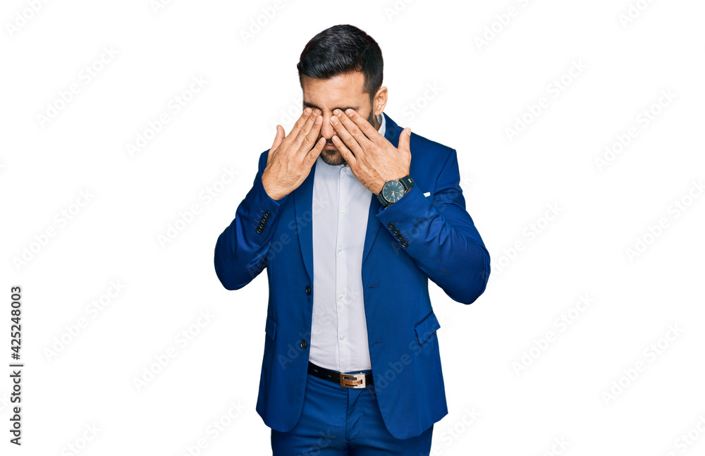 Young hispanic man wearing business jacket rubbing eyes for fatigue and headache, sleepy and tired expression. vision problem Young hispanic man wearing business jacket rubbing eyes for fatigue and headache, sleepy and tired expression. vision problem