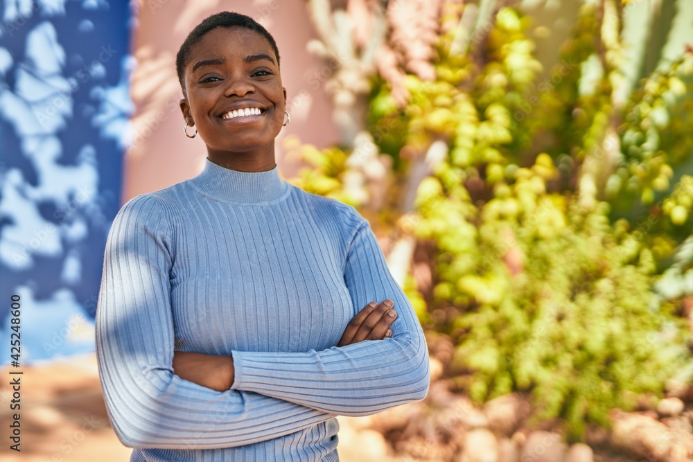 Young african american woman smiling happy with crossed arms at the city. Young african american woman smiling happy with crossed arms at the city.