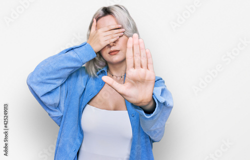 Wallpaper Mural Young blonde girl wearing casual clothes covering eyes with hands and doing stop gesture with sad and fear expression. embarrassed and negative concept. Torontodigital.ca