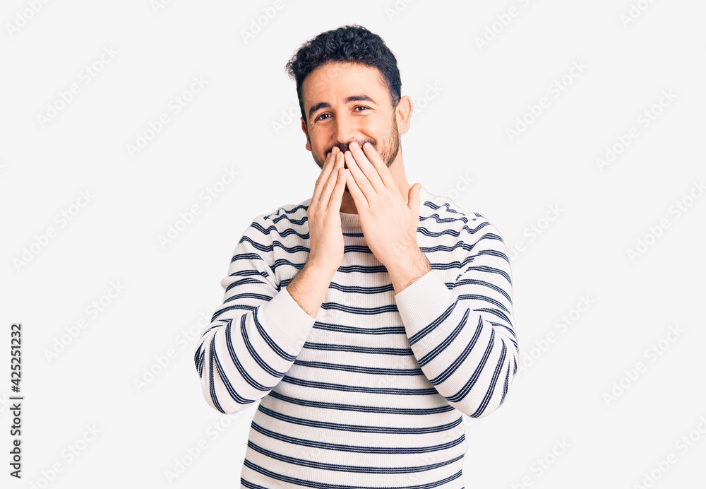 Young hispanic man wearing casual clothes laughing and embarrassed giggle covering mouth with hands, gossip and scandal concept Young hispanic man wearing casual clothes laughing and embarrassed giggle covering mouth with hands, gossip and scandal concept