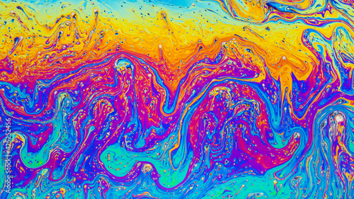 Fluid soap bubble psychedelic colorful abstract art. Surreal patterns with rainbows and waves of color in motion. photo