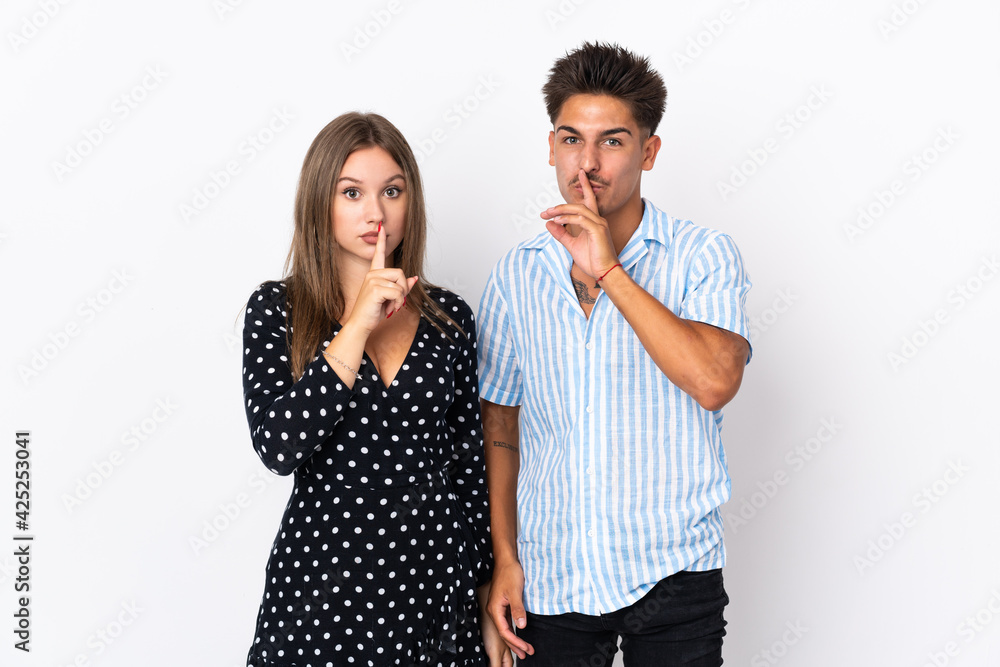 Young caucasian couple isolated on white background showing a sign of closing mouth and silence gesture Young caucasian couple isolated on white background showing a sign of closing mouth and silence gesture