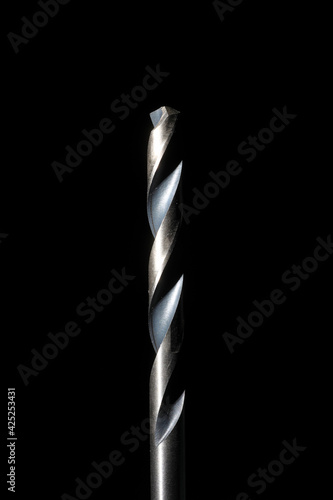 Closeup of high speed steel drill bit with black background