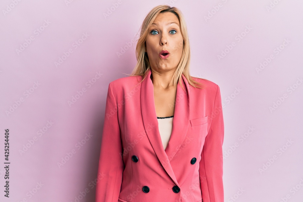 Middle age caucasian woman wearing business jacket afraid and shocked with surprise expression, fear and excited face. Middle age caucasian woman wearing business jacket afraid and shocked with surprise expression, fear and excited face.