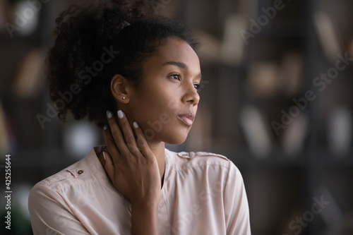 Pensive African American woman look in distance thinking dreaming of future success or opportunities. Thoughtful biracial young female imagine or visualize. Dreamer, vision, visualization concept.