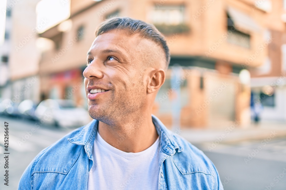 Young caucasian man smiling happy walking at the city. Young caucasian man smiling happy walking at the city.