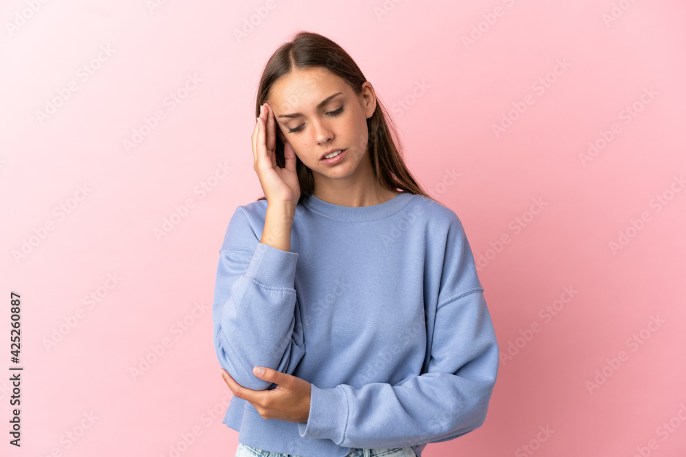 Young woman over isolated pink background with headache Young woman over isolated pink background with headache
