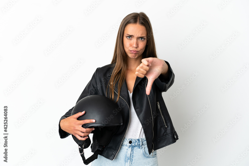 Woman with a motorcycle helmet over isolated white background showing thumb down with negative expression Woman with a motorcycle helmet over isolated white background showing thumb down with negative expression