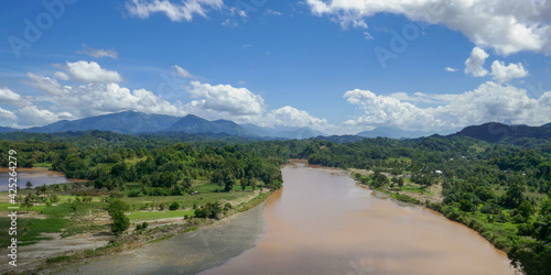 Scenic tropical rural landscape with Sadang river, forest and mountain background near Enrekang, South Sulawesi, Indonesia