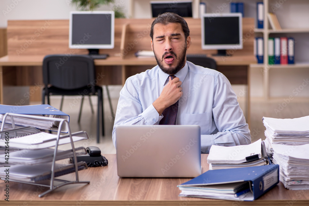 Young businessman employee unhappy with excessive work in the of Young businessman employee unhappy with excessive work in the of