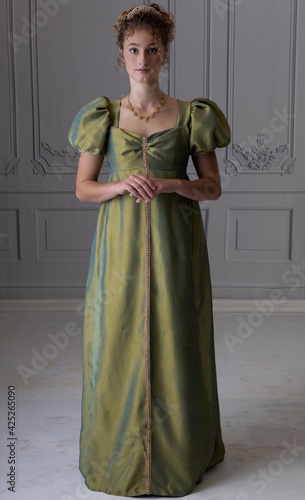 Photography A young Regency woman wearing a green shot silk dress and shown from in front of