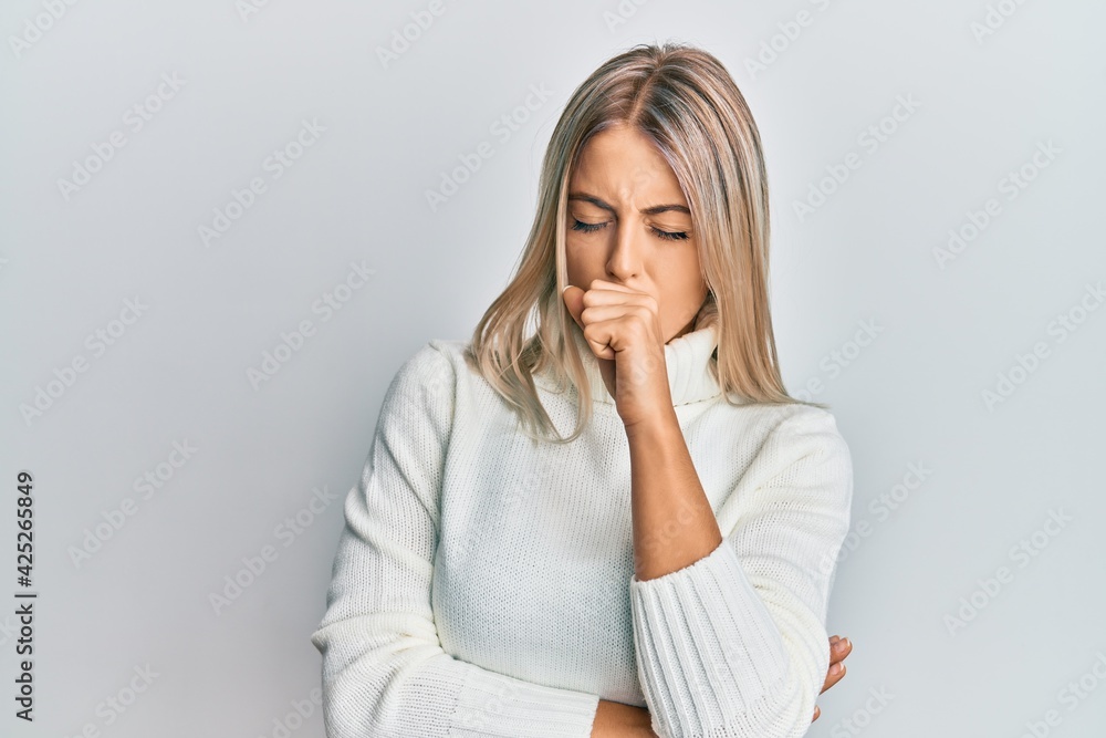 Beautiful blonde woman wearing casual turtleneck sweater feeling unwell and coughing as symptom for cold or bronchitis. health care concept. Beautiful blonde woman wearing casual turtleneck sweater feeling unwell and coughing as symptom for cold or bronchitis. health care concept.