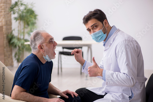 Old male patient visiting young male doctor otorhinolaryngologis © Elnur