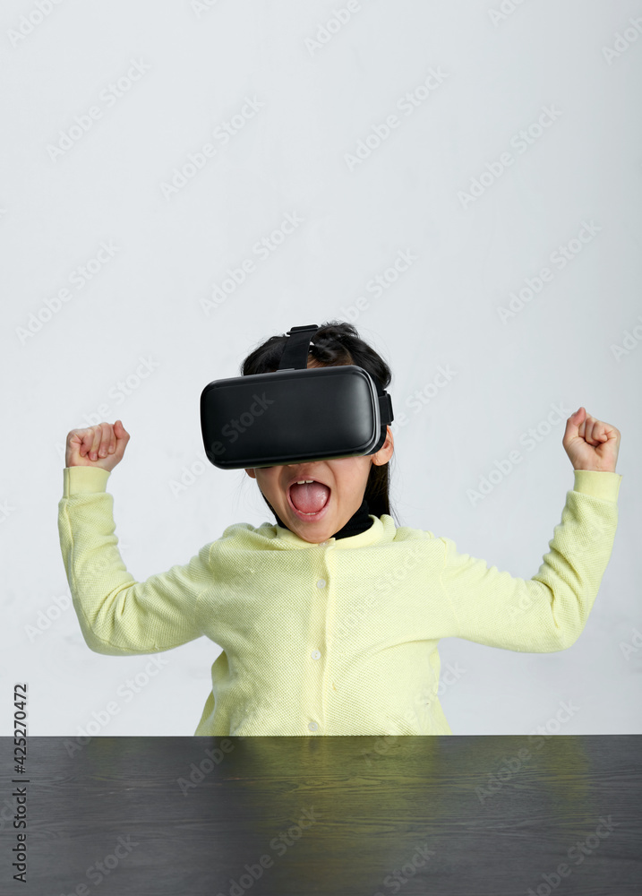 Cute Asian little girl playing with VR glasses Cute Asian little girl playing with VR glasses