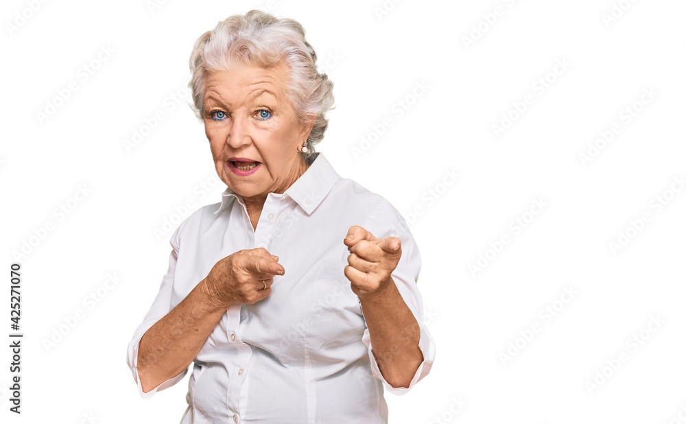 Senior grey-haired woman wearing casual clothes pointing fingers to camera with happy and funny face. good energy and vibes. Senior grey-haired woman wearing casual clothes pointing fingers to camera with happy and funny face. good energy and vibes.