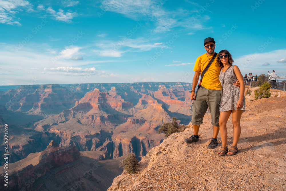 A young couple in the sunset views at Mojave Point in Grand Canyon. Arizona.