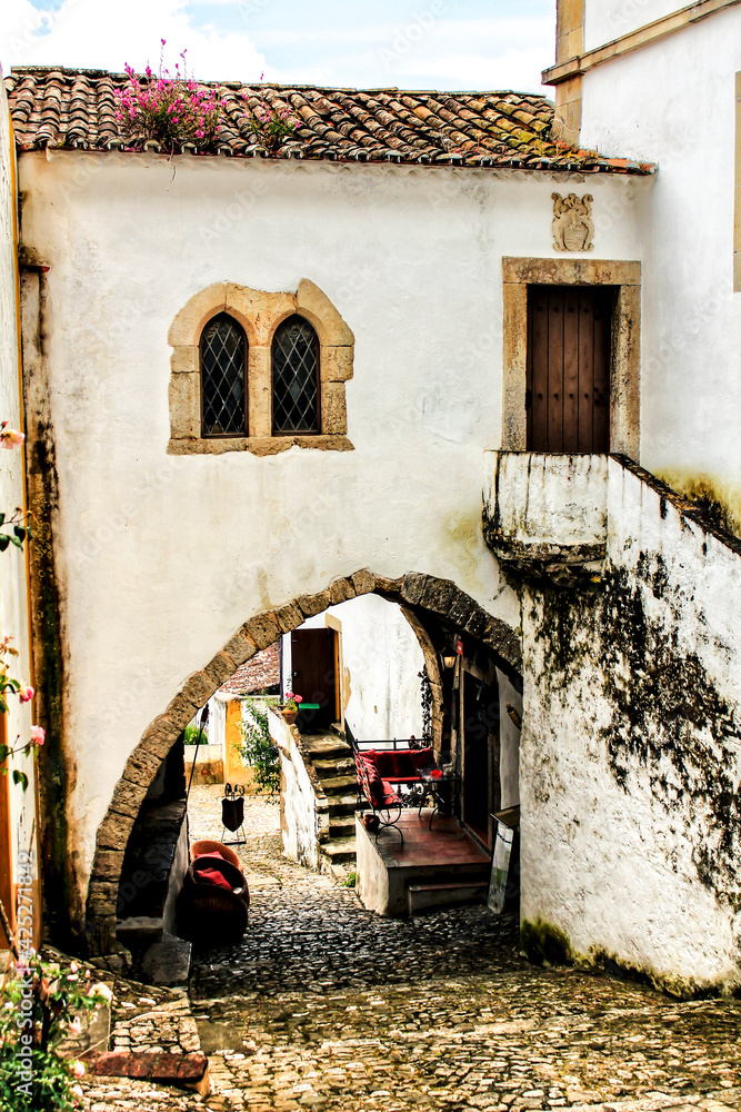 Narrow and colorful streets, facades and balconies of Obidos