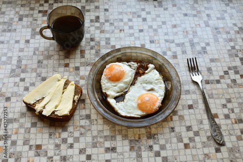 fried eggs on the kitchen table, traditional breakfast