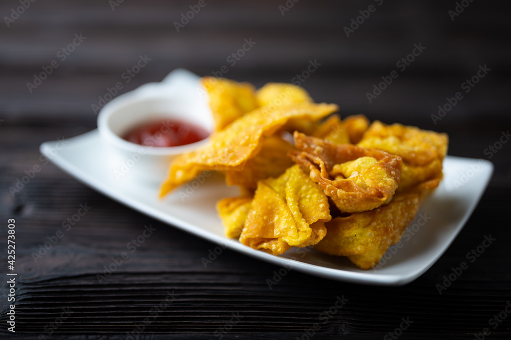 Deep fired Chinese Thai style wonton with minced pork and sweet and sour sauce in ceramic dish. Deep fired Chinese Thai style wonton with minced pork and sweet and sour sauce in ceramic dish.