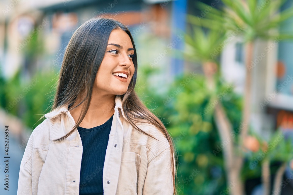 Young hispanic girl smiling happy standing at the city. Young hispanic girl smiling happy standing at the city.