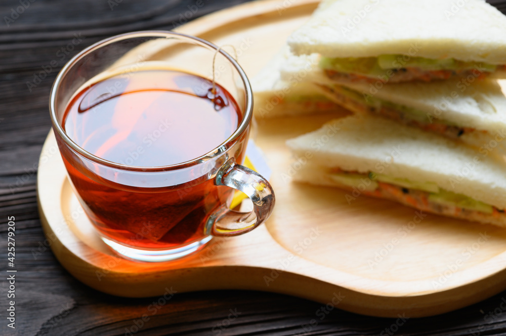 Hot Tea with Tuna Sandwich on wooden plate Hot Tea with Tuna Sandwich on wooden plate