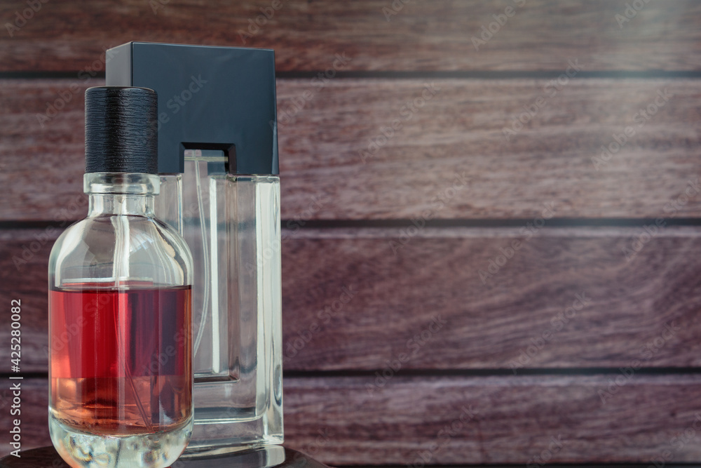 Men's perfume in a bottle on a light brick background. Men's perfume in a bottle on a light brick background.
