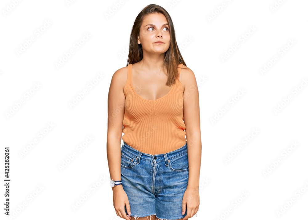 Young caucasian woman wearing casual clothes smiling looking to the side and staring away thinking. Young caucasian woman wearing casual clothes smiling looking to the side and staring away thinking.