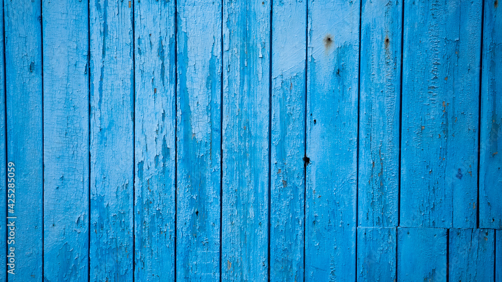 Aged blue planks with peeled paint. Blue background. Close-up. Copy space. Defocus. Aged blue planks with peeled paint. Blue background. Close-up. Copy space. Defocus.