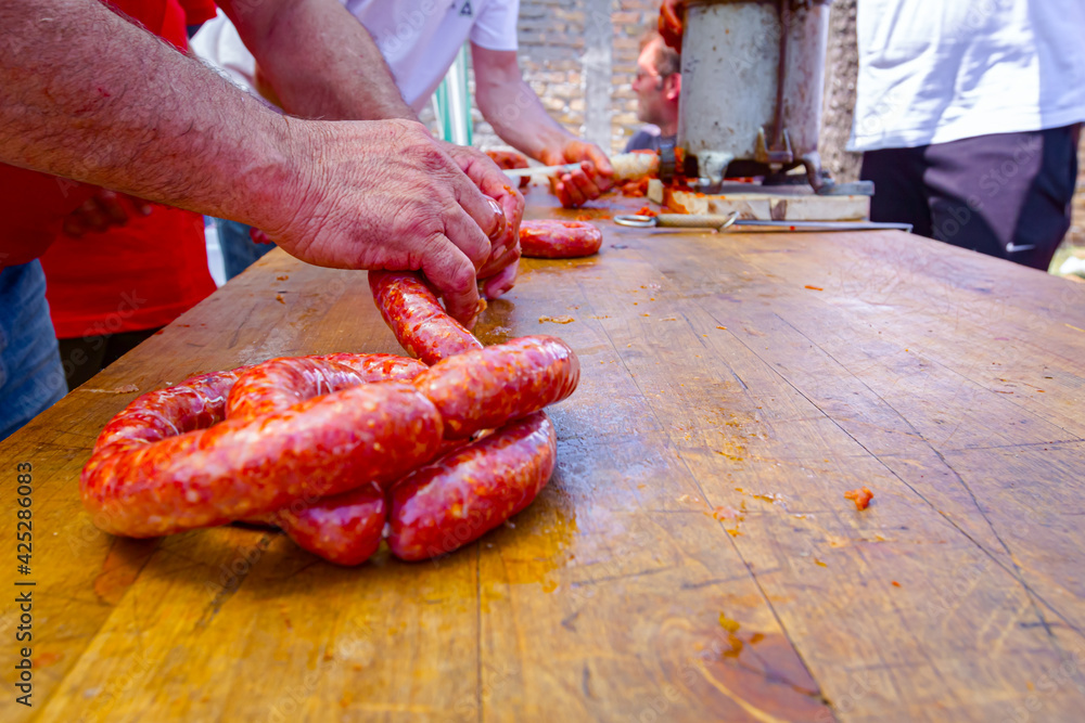 Twist pig intestines with minced meat to make handmade sausages