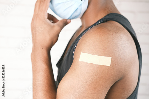 adhesive bandage on young man's arm 