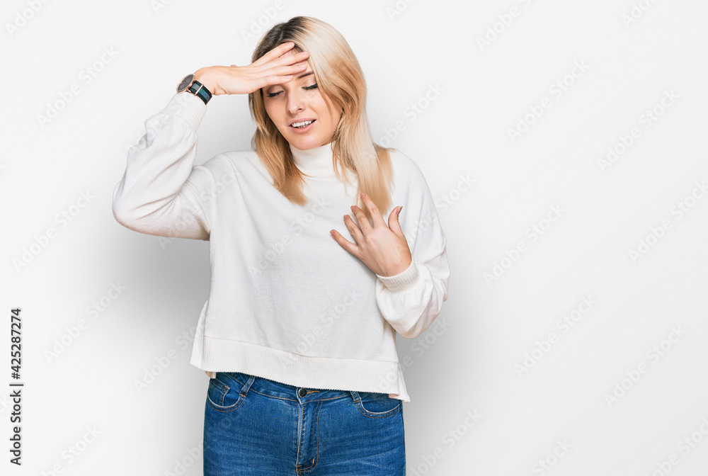 Young caucasian woman wearing casual winter sweater touching forehead for illness and fever, flu and cold, virus sick Young caucasian woman wearing casual winter sweater touching forehead for illness and fever, flu and cold, virus sick