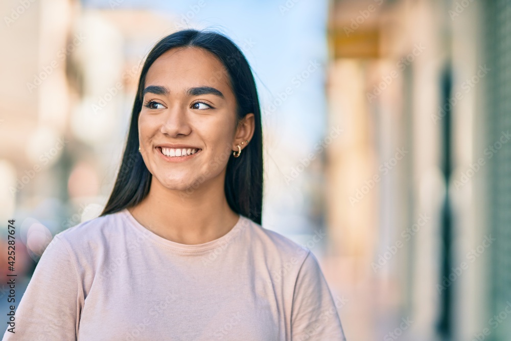 Young latin girl smiling happy standing at the city. Young latin girl smiling happy standing at the city.