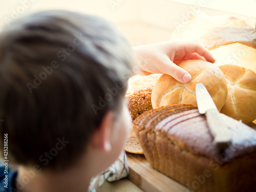 Child reaching for a bread roll