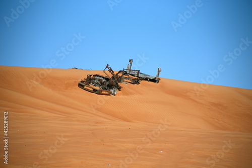 Burned and abonded car Around Nazwa and pink rock desert, viewing of the sand and plant in the desert, sharjah, United Arab Emirates photo