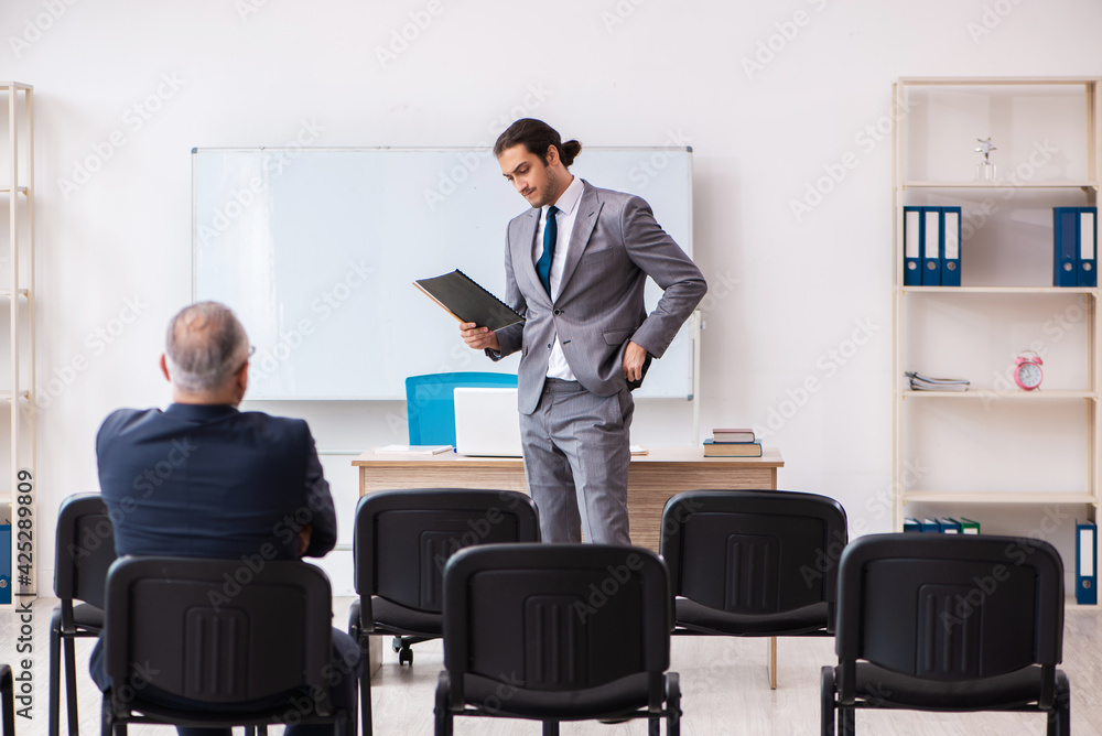 Two businessmen in the classroom in pandemic concept Two businessmen in the classroom in pandemic concept