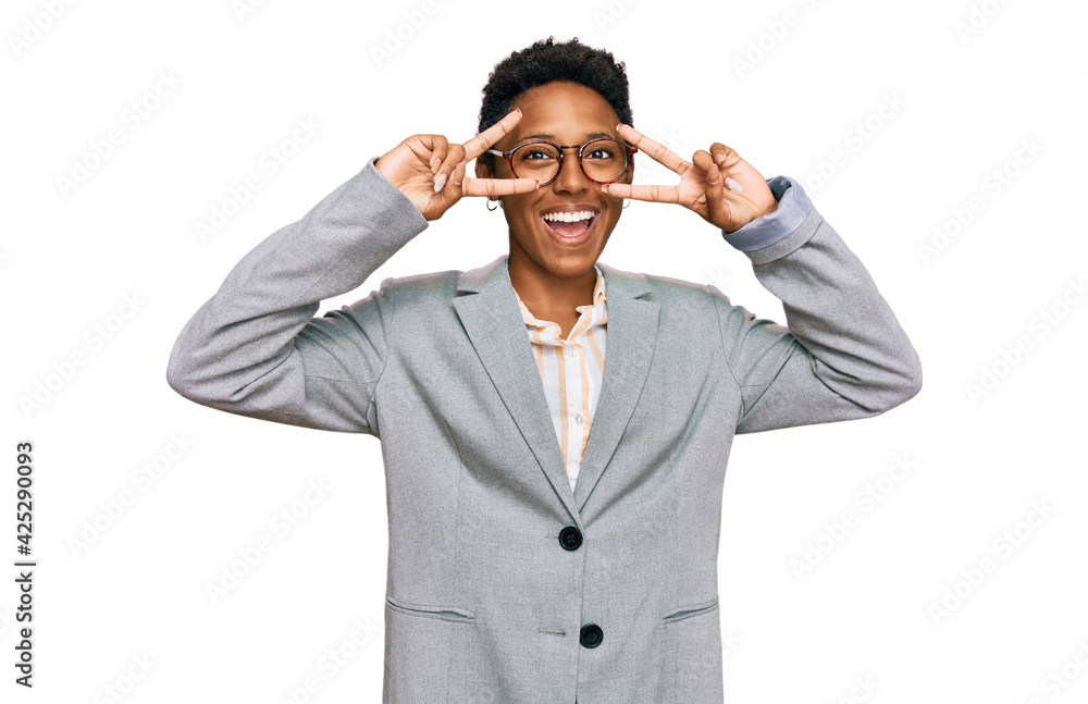 Young african american woman wearing business clothes doing peace symbol with fingers over face, smiling cheerful showing victory Young african american woman wearing business clothes doing peace symbol with fingers over face, smiling cheerful showing victory