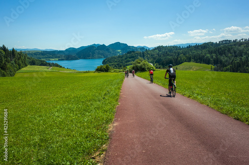 Cycling around Czorsztynskie lake near Niedzica village on sunny spring day, Pieniny Mountains, Poland