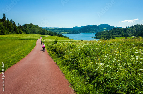 Cycling around Czorsztynskie lake near Niedzica village on sunny spring day, Pieniny Mountains, Poland