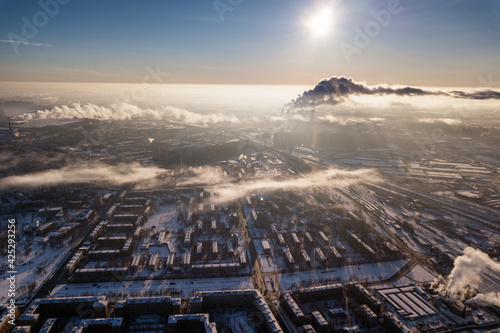 Winter city in the clouds from a drone