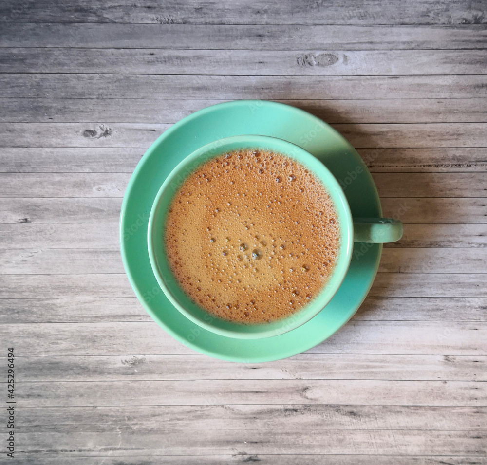 Blue coffee cup and saucer shot on wooden surface. Top view, from above, flat lay. Coffee break background. Blue coffee cup and saucer shot on wooden surface. Top view, from above, flat lay. Coffee break background.